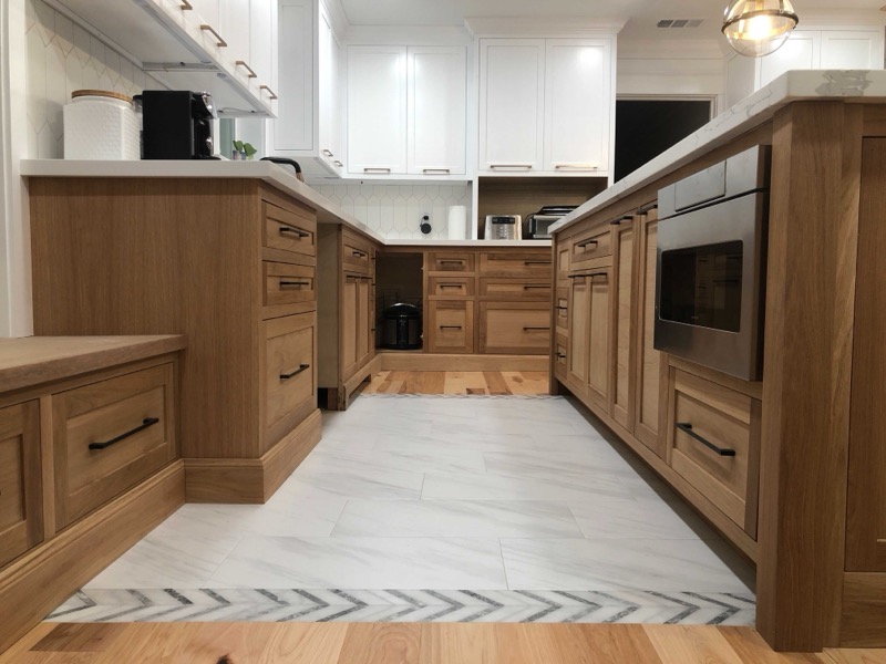 Custom oak cabinetry with marble tile flooring in Houston kitchen