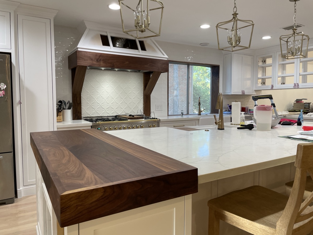 Custom kitchen with walnut butcher block countertop and range hood in Houston