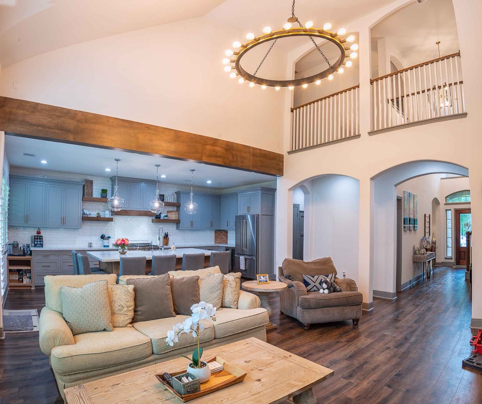 Open concept living space in a Houston home after load bearing wall removal with a wrapped beam
